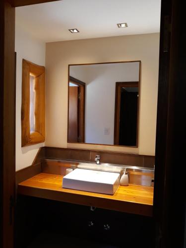 a bathroom with a sink and a large mirror at Casas Juanjo in Mar de las Pampas