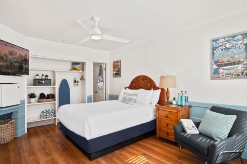 a bedroom with a bed and a chair at Sea Blue Hotel in Los Angeles