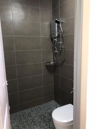 a bathroom with a toilet and a shower at Budget for 12 in Ipoh