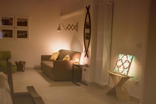 a living room with a couch and a lamp at Ai Sottani B&B Deluxe Suite in Gioia del Colle