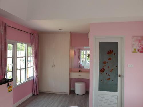 różowa łazienka z umywalką i lustrem w obiekcie Bunny Hill Resort w mieście Chon Buri