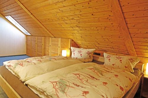 a bed in a room with a wooden ceiling at Ferienwohnung mit Wasserbett FW3 in Saalfeld