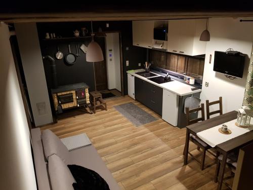 a kitchen and living room with a couch and a table at Osada Knurów in Knurów