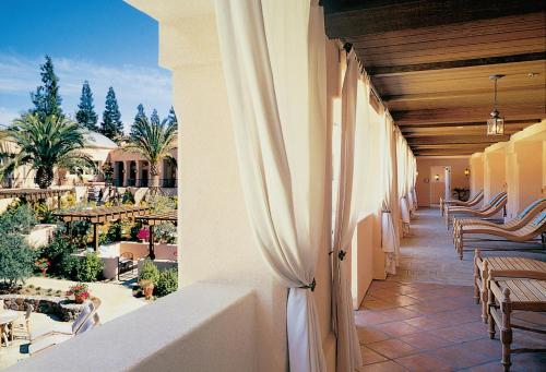a balcony of a resort with chairs and tables at Fairmont Sonoma Mission Inn & Spa in Sonoma