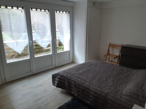 オーレーにあるAppartement sur les Quais de St Goustanのベッドルーム1室(ベッド1台付)、ガラスのスライドドア2つが備わります。