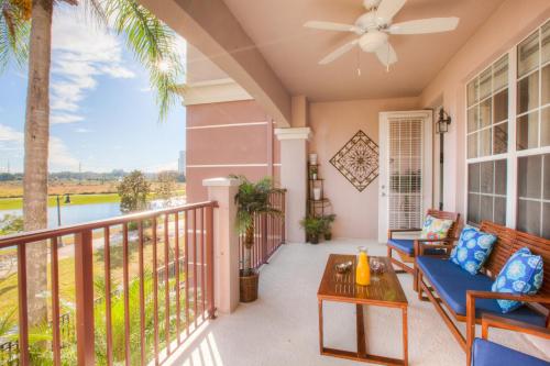 a porch with a blue couch and a table at Casiola Vacation Homes in Orlando