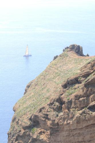 a sail boat in the water on a mountain at Vivenda Belo Horizonte in Caniço