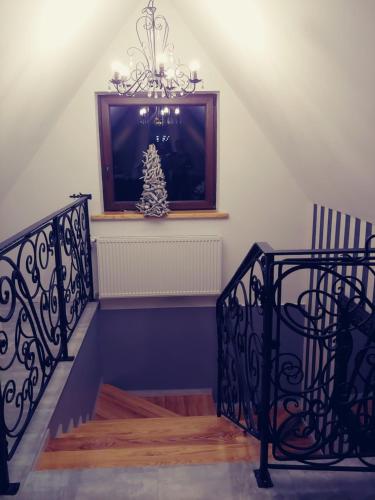 a staircase with a christmas tree in a window at U Hanki in Biały Dunajec