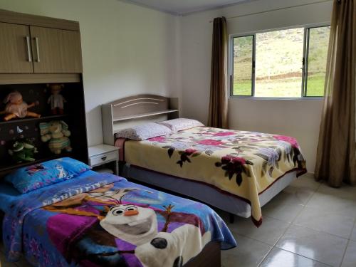 En eller flere senge i et værelse på Casa de Campo Passo do Tatu