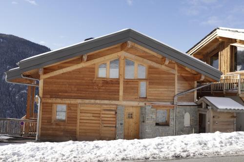 a log cabin with snow in front of it at Le Falyoucher in Peisey-Nancroix