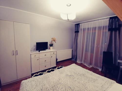 a bedroom with a tv and a dresser with a dresserngthngthngth at U Hanki in Biały Dunajec