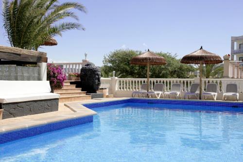a swimming pool with chairs and umbrellas at Hotel Boutique Bon Repos - Adults Only in Santa Ponsa