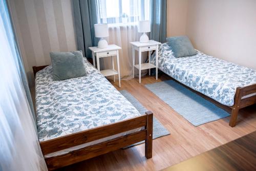 a bedroom with two beds and two night stands at "Staromiejskie" in Zamość