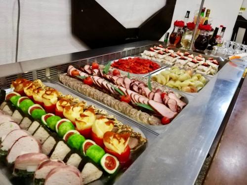 a buffet line with many different types of sushi at Vila Teleconstructia in Slănic-Moldova