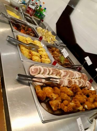a buffet line with many different types of food at Vila Teleconstructia in Slănic-Moldova