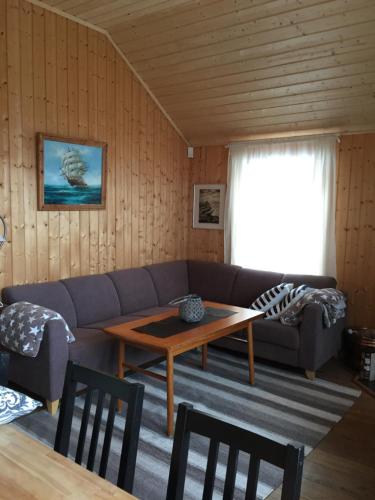 a living room with a couch and a table at Svolværgeita Apartments in Svolvær