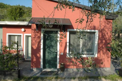 a red house with a door in front of it at La Luna - dependance in Bardolino