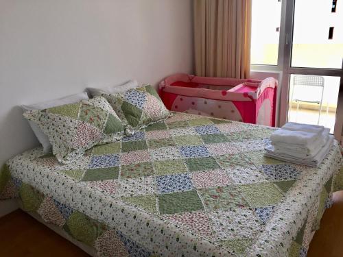 a bedroom with a bed with a quilt on it at El MATE apartment Sea Garden and Beach Varna in Varna City