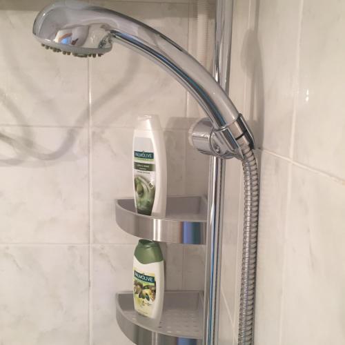 a shower shelf in a bathroom with toothbrushes on it at El MATE apartment Sea Garden and Beach Varna in Varna City