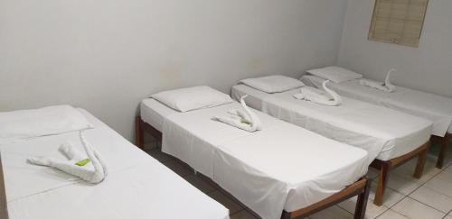 A bed or beds in a room at Hotel Brasão