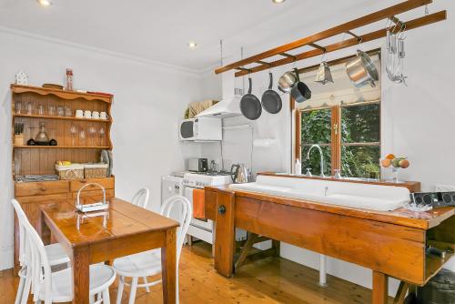 a kitchen with a large white sink and a table at Aldgate Creek Cottage Bed and Breakfast in Aldgate