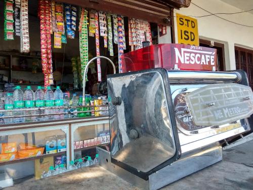 a store with a mercedes benz car parked in front of a store at Shubham Home Stay in Kausani