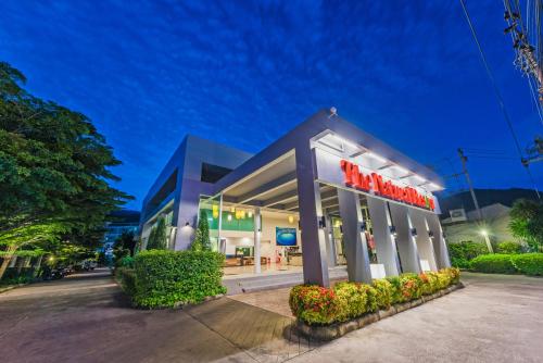 a macys store with a neon sign in front of it at Tuana Hotels The Natural Resort in Patong Beach