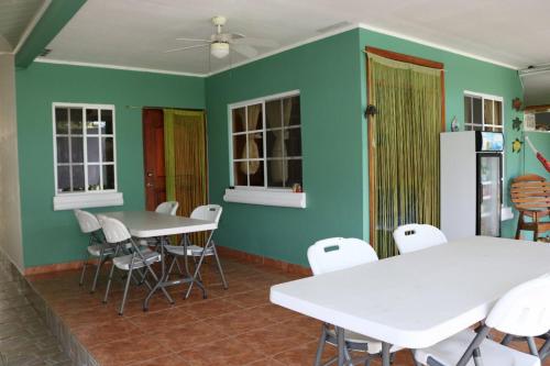 a dining room with white tables and white chairs at Bed and Breakfast Little Italy in Boquerón