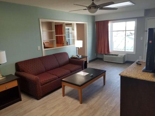 a living room with a couch and a coffee table at Best Western Plus Holiday Sands Inn & Suites in Norfolk