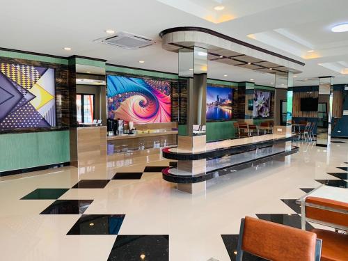 a lobby with a restaurant with colorful walls at โรงแรมมาลินี in Surin