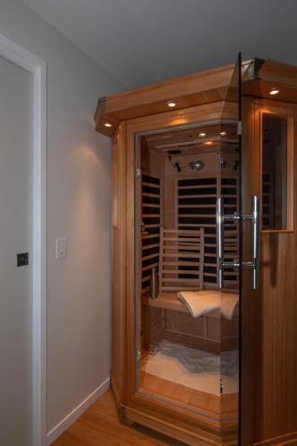 a room with a glass door to a room with a table at Adventure Bay Beach House in Adventure Bay