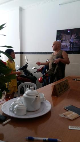 a group of three men sitting around a table with a table at Hotel Hoai Anh in Vung Tau