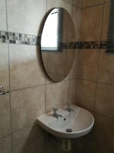 a bathroom with a sink and a mirror at Kalahari Rus in Upington