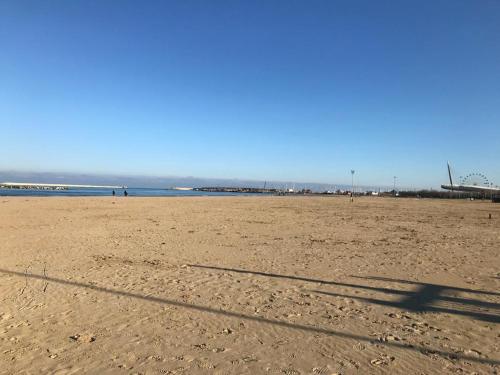 a shadow of a kite on a sandy beach at Blue Apartment in Pescara