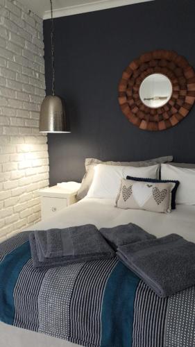 a bedroom with a bed with a black wall at Oppermans Villa in Pretoria