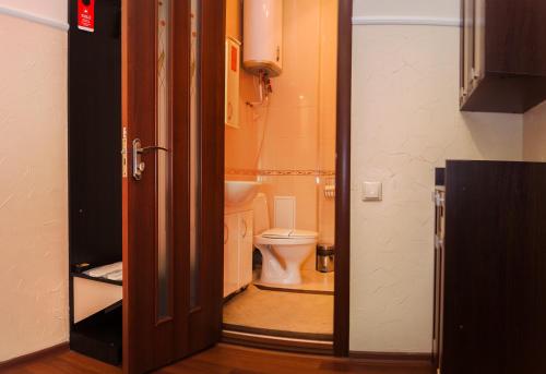 an open door to a bathroom with a toilet at Helen Hotel in Mykolaiv