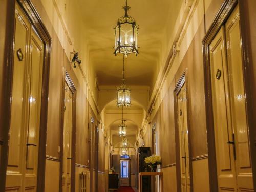 an empty hallway with a chandelier in a building at Hotel Portofino in Rapallo