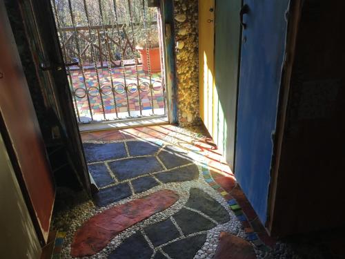 an open door leading to a patio with a gate at Casa toscana in Thun