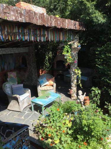 a patio with chairs and a table and a stone fireplace at Casa toscana in Thun