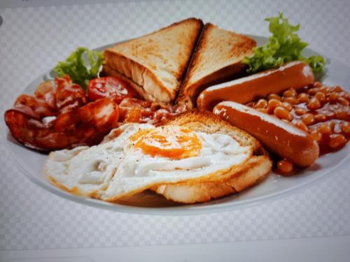 a plate of breakfast food with eggs beans and toast at Kalahari Rus in Upington