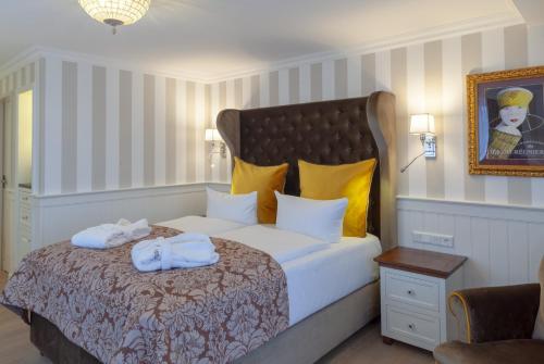 a bedroom with a bed with towels on it at Europa Hotel Kühlungsborn in Kühlungsborn