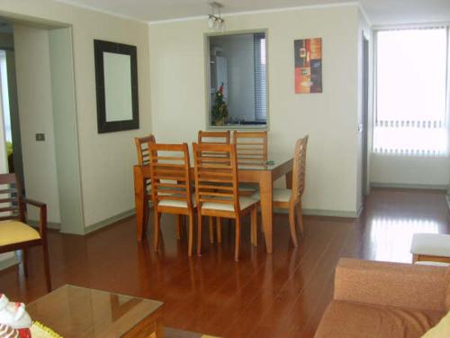 a living room with a dining room table and chairs at Departamento Viña del Mar in Viña del Mar