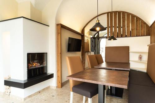 a dining room with a table and a fireplace at Gästehaus Ferk - Frühstückspension, Bed & Breakfast in Bad Radkersburg