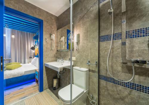 a bathroom with a shower and a toilet and a sink at Boutique Hotel Zelenyy Teatr in Simferopol