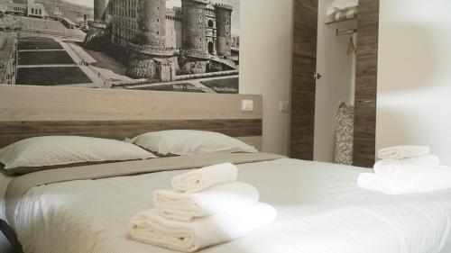 a bedroom with a bed with towels on it at Donna Vicenza Bed & Breakfast in Naples