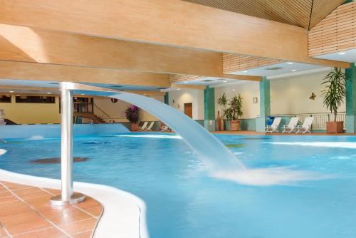 a pool with a water slide in a hotel at Hotel Sonnenhügel in Bad Kissingen