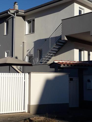 a building with a white fence and stairs on it at B&B Purple Italy in Fiumicino