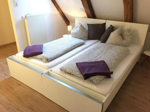 a white couch with pillows on it in a room at LemperDenkmal Münster in Münster