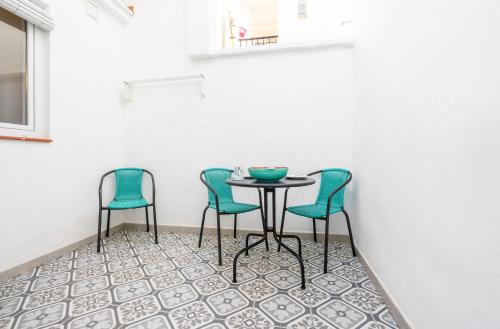 a table and two chairs on a tile floor at Carrasco 4 in Vélez-Málaga