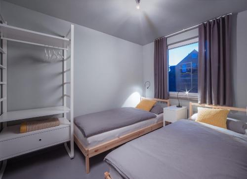a bedroom with two bunk beds and a window at NordseeHeide-Lodges Cuxhaven in Cuxhaven